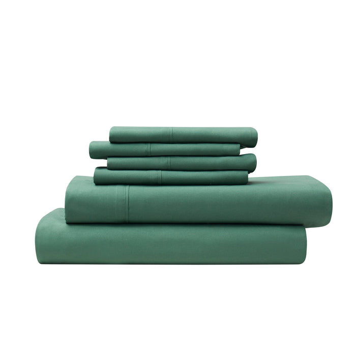 Set of green bedding sheets and pillowcases on a white background