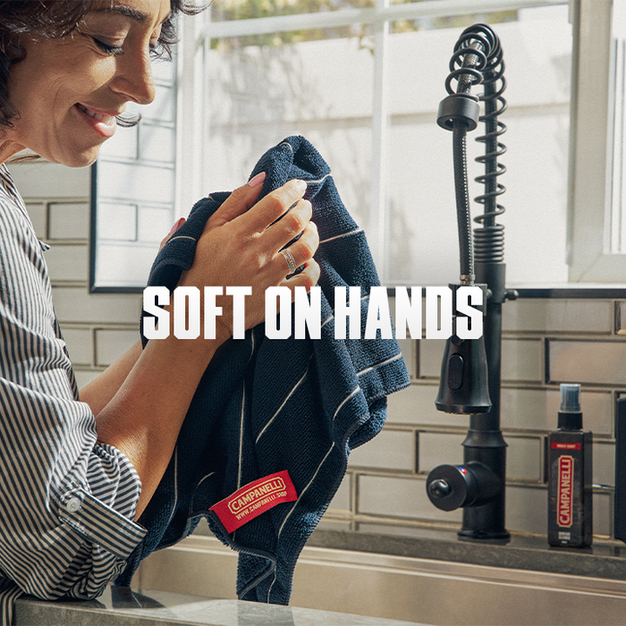 Person using a Campbell's branded towel in a bathroom setting with text 'Soft on Hands'.